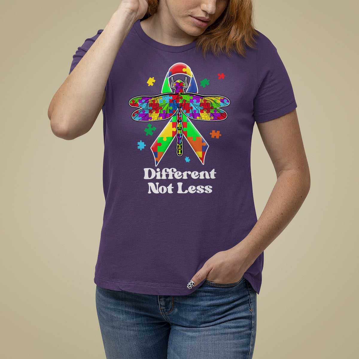 Purple autism awareness T-shirt with colorful puzzle dragonfly graphic and “Different Not Less”