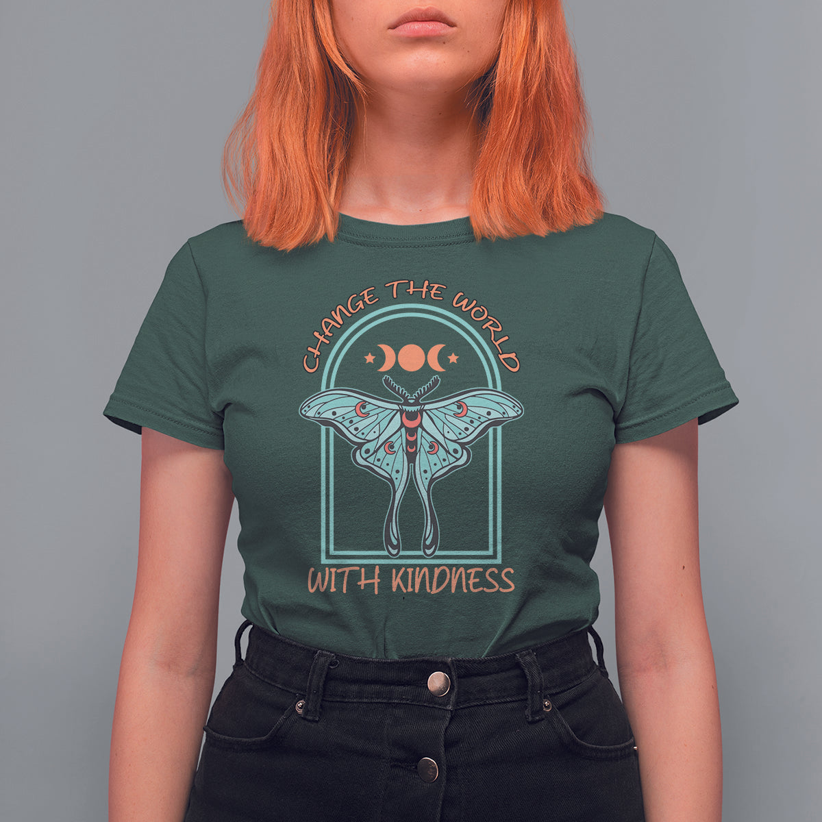 Dark forest green women’s t-shirt with teal luna moth graphic and “with kindness” slogan