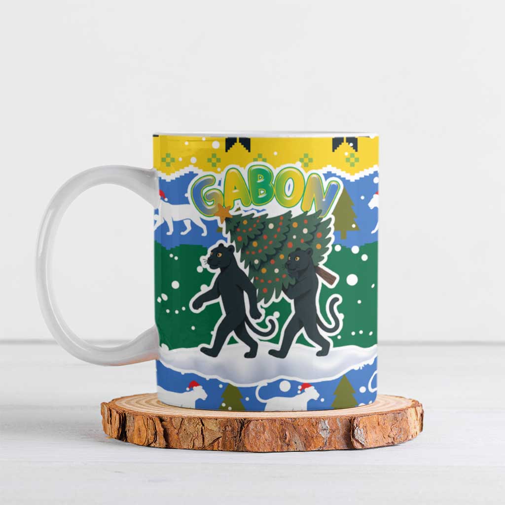 Gabon Christmas Ceramic Mug with Black Panthers Carrying Tree and Green Yellow Snowflake Pattern - Wonder Print Shop