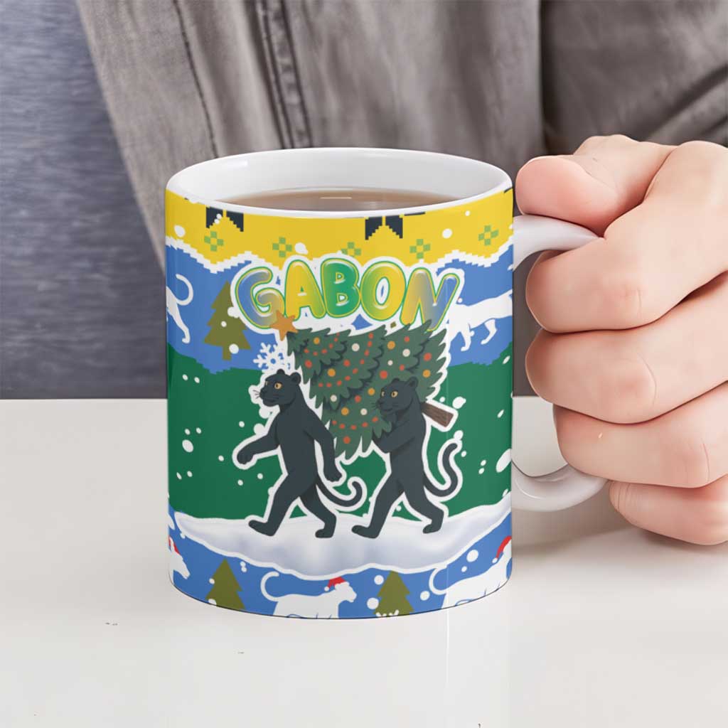 Gabon Christmas Ceramic Mug with Black Panthers Carrying Tree and Green Yellow Snowflake Pattern - Wonder Print Shop