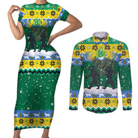 Gabon Christmas Couples Matching Short Sleeve Bodycon Dress and Long Sleeve Button Shirt with Black Panthers Carrying Tree and Green Yellow Snowflake Pattern - Wonder Print Shop