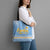 Argentina Christmas Tote Bag with Blue-White Snowflake Pattern, Sun Emblem, and Gaucho Santa Riding Horse Motif - Wonder Print Shop
