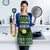 Guadeloupe Christmas Apron with Green-Red Plaid Design, Sun and Sugarcane Emblem, and Santa Sleigh Motif - Wonder Print Shop