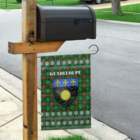 Guadeloupe Christmas Garden Flag with Green-Red Plaid Design, Sun and Sugarcane Emblem, and Santa Sleigh Motif - Wonder Print Shop