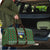 Guadeloupe Christmas Travel Bag with Green-Red Plaid Design, Sun and Sugarcane Emblem, and Santa Sleigh Motif - Wonder Print Shop
