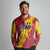 Chad Christmas Long Sleeve Polo Shirt with Red-Yellow Festive Pattern, National Coat of Arms, and Snowflake Accents - Wonder Print Shop