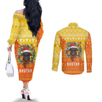 Bhutan Christmas Couples Matching Off The Shoulder Long Sleeve Dress and Long Sleeve Button Shirt with Takin Reindeer Antlers Santa Hat and Yellow Orange Holiday Pattern - Wonder Print Shop