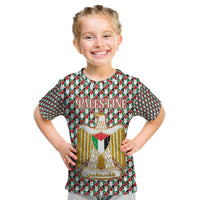 Palestine Christmas Kid T Shirt with Red-Green Pattern, Golden Eagle Emblem, and Jesus Holding Flag Motif - Wonder Print Shop