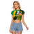 Saint Kitts and Nevis Apparel Raglan Cropped T Shirt with Coat of Arms, Palm Trees, and Hammock Graphic in Tropical Green and Flag-Inspired Design - Wonder Print Shop