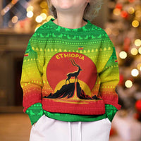 Ethiopia Christmas Kid Ugly Christmas Sweater with Mountain Gazelle Sunset Ethiopian Flag Colors and Tribal Pattern Design - Wonder Print Shop