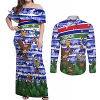 Gambia Christmas Couples Matching Off Shoulder Maxi Dress and Long Sleeve Button Shirt with Santa Birds Gift Boxes Forest Scene and Snowflake Pattern Design - Wonder Print Shop