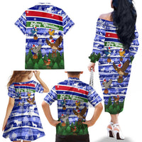 Gambia Christmas Family Matching Off The Shoulder Long Sleeve Dress and Hawaiian Shirt with Santa Birds Gift Boxes Forest Scene and Snowflake Pattern Design - Wonder Print Shop