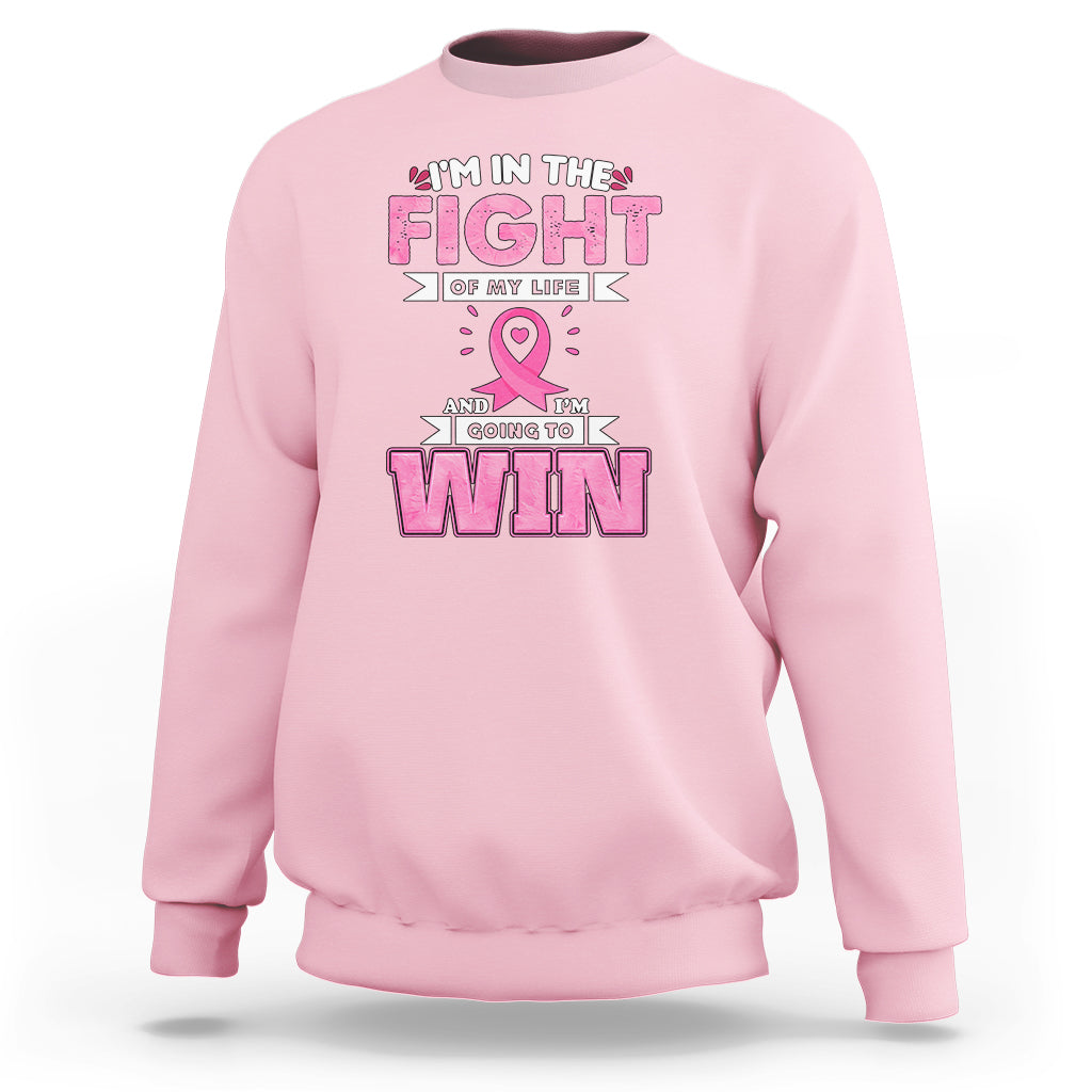 Light pink crewneck sweatshirt with pink ribbon and 'FIGHT' and 'WIN' graphic print