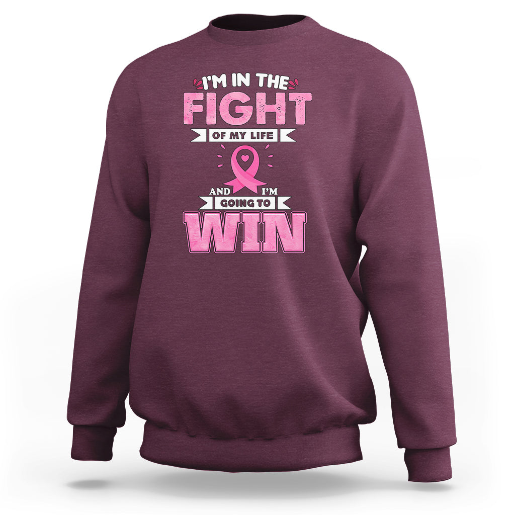 Maroon crewneck sweatshirt with pink ribbon and 'FIGHT' and 'WIN' graphic print