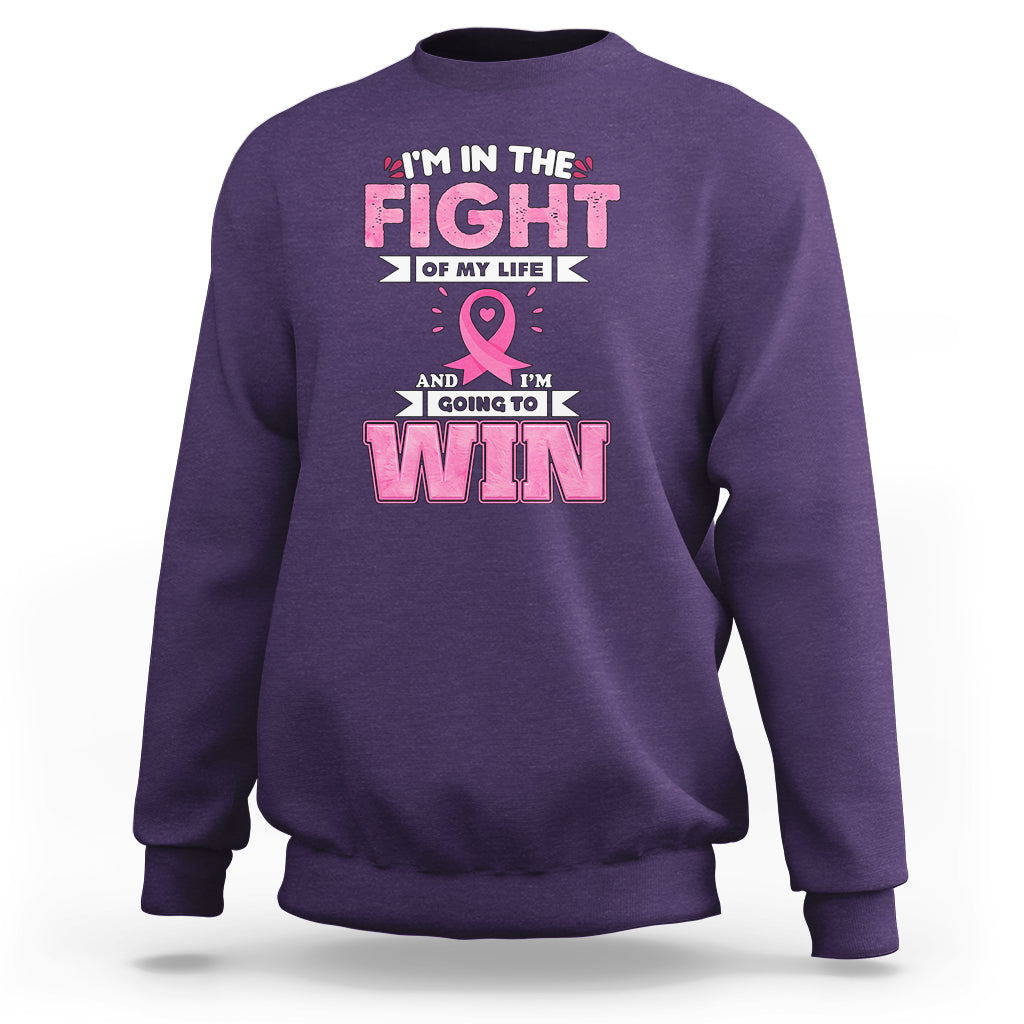 Purple crewneck sweatshirt with pink ribbon and 'FIGHT' and 'WIN' graphic print