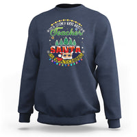 Navy teacher sweatshirt with colorful Santa-watching holiday graphic on chest.
