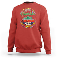Red teacher sweatshirt with colorful Santa-watching holiday graphic on chest.