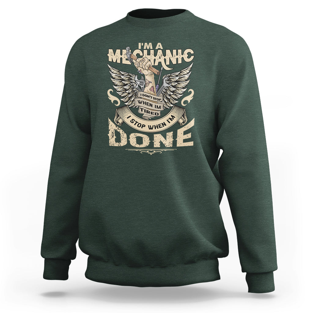 Dark forest green crewneck mechanic sweatshirt with winged “DONE” graphic on front.