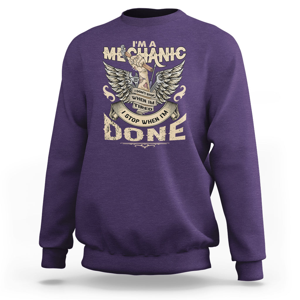 Purple crewneck mechanic sweatshirt with winged “DONE” graphic on the front.