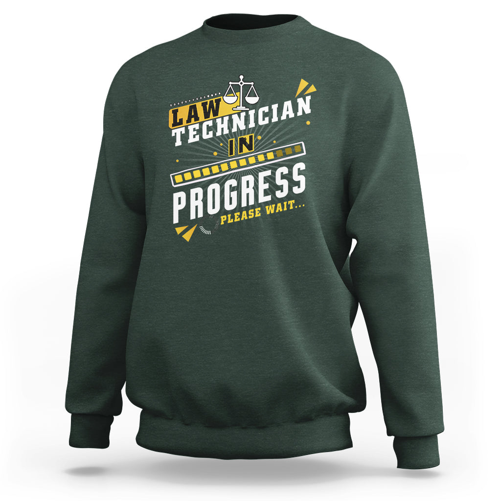 Dark forest green crewneck sweatshirt with filmstrip "In Progress" graphic and scales icon
