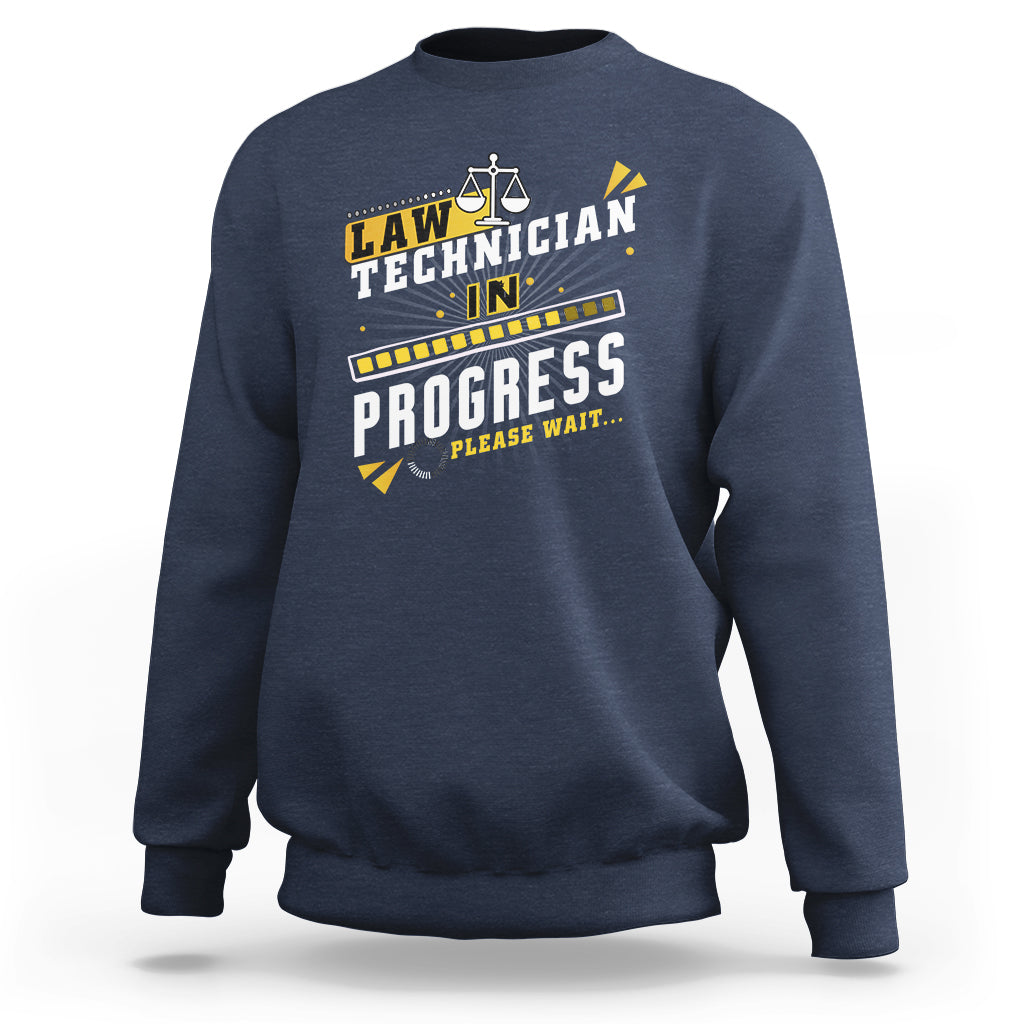 Navy crewneck sweatshirt with filmstrip "In Progress" graphic and scales icon