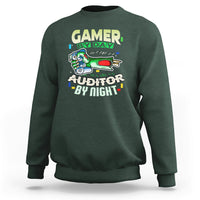 Dark forest green crewneck sweatshirt with “GAMER BY DAY” and “AUDITOR BY NIGHT” chest graphic.