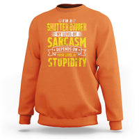 Orange crewneck sweatshirt with yellow “Sarcasm” driver graphic on the chest