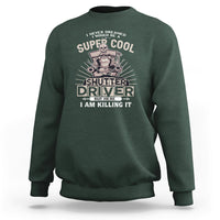 Dark forest green crewneck sweatshirt with front “Shutter Driver” graphic print.