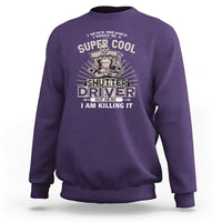 Purple crewneck sweatshirt with front “Shutter Driver” graphic print.