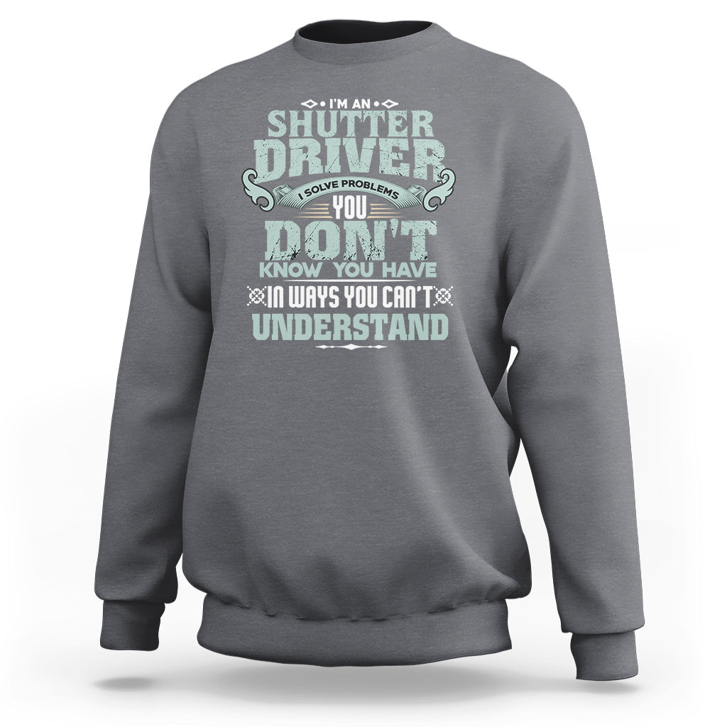 Charcoal crewneck sweatshirt with large front “Shutter Driver” graphic print.