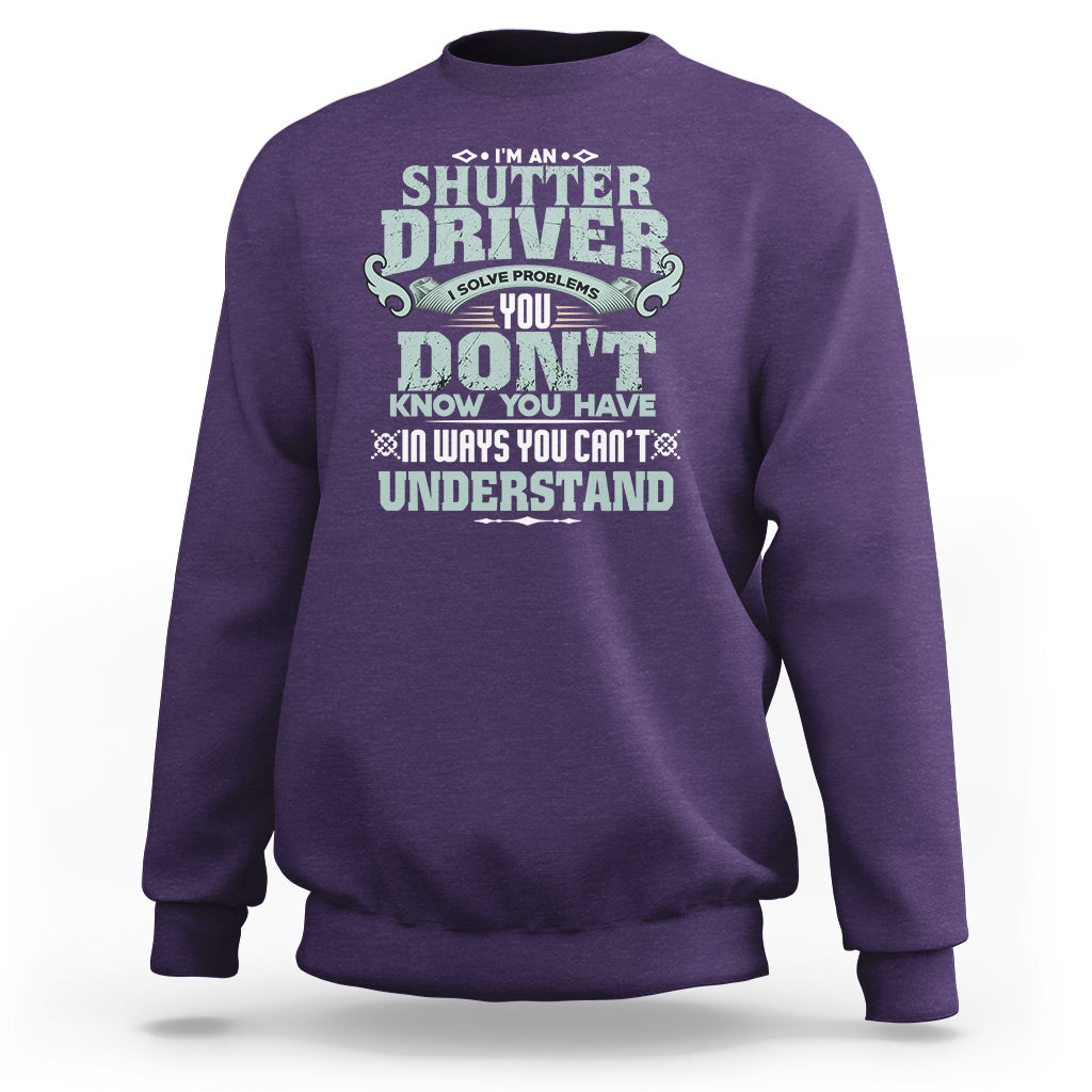 Purple crewneck sweatshirt with large front “Shutter Driver” graphic print.