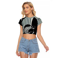 Striped Bass Jumping Graphic Raglan Cropped T Shirt Rod Reel and Airplane on Fish Scale Pattern - Wonder Print Shop