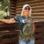 Rainbow Trout Fishing Women Polo Shirt with Camouflage Reeds and Forest Background in Nature-Inspired Colors - Wonder Print Shop