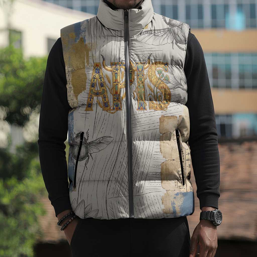Apis Ancient Egyptian Sleeveless Puffer Jacket with Beige-Gray Hieroglyphic, Ornate Bull Head, and Gold-Blue Typography - Wonder Print Shop
