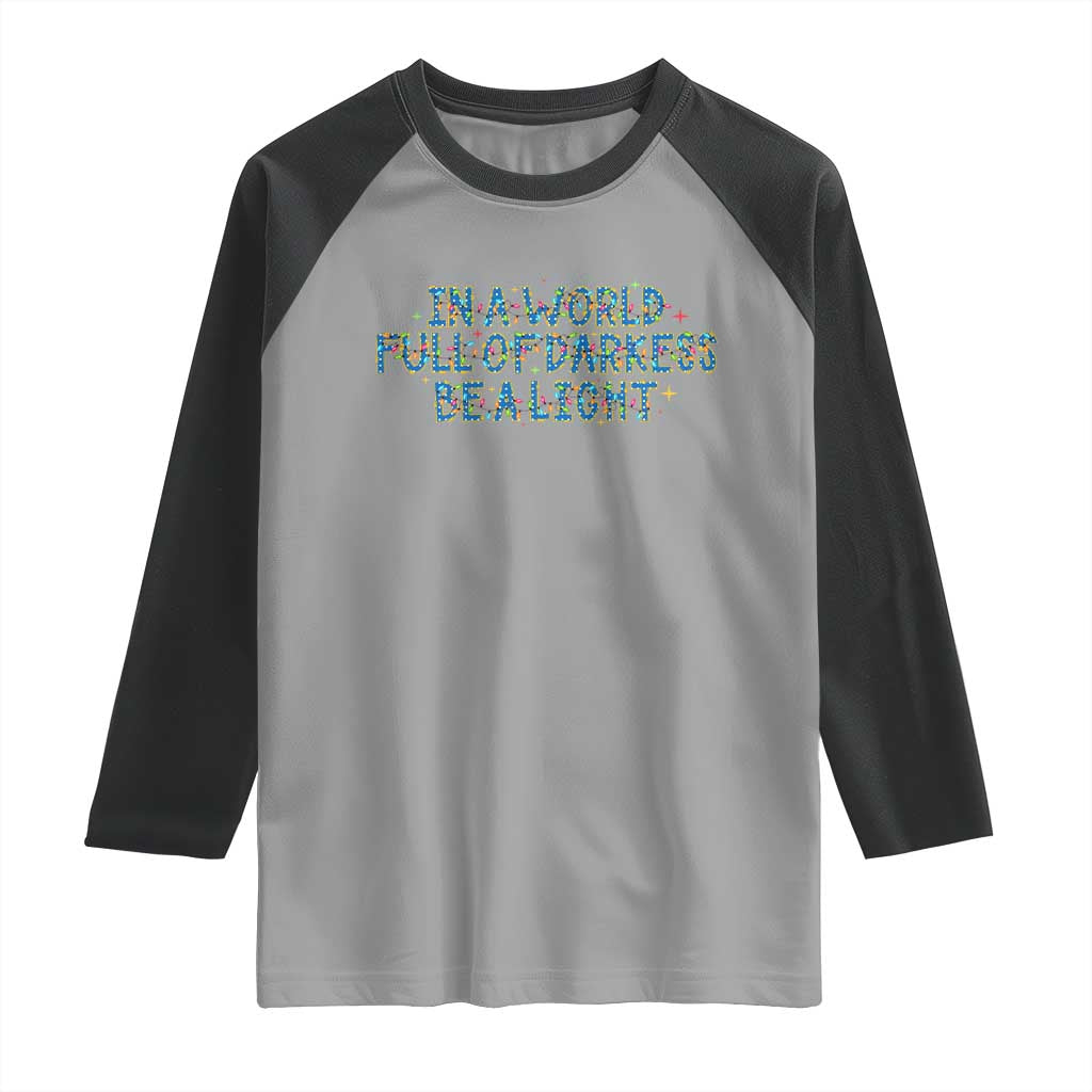 In A World Full Of Darkness Be A Light Raglan Shirt Christmas Quote Gift - Wonder Print Shop