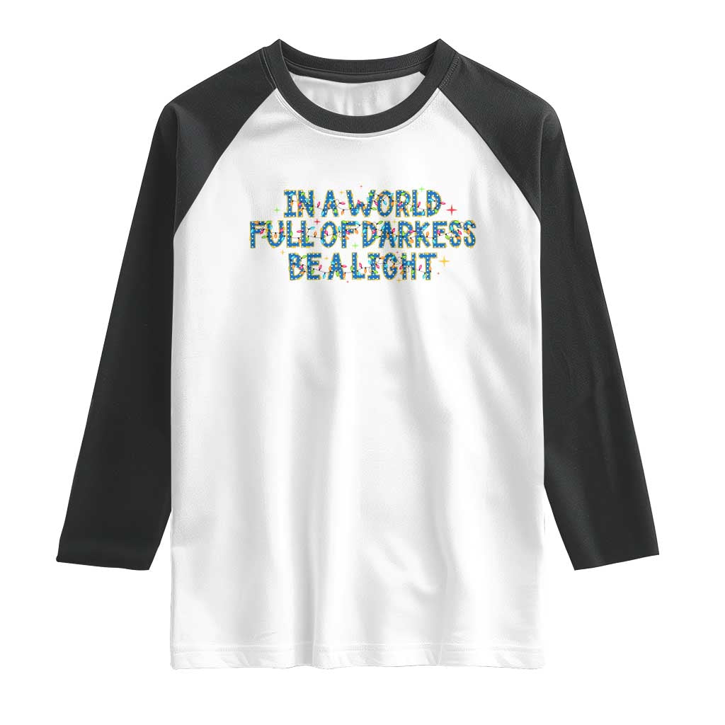 In A World Full Of Darkness Be A Light Raglan Shirt Christmas Quote Gift - Wonder Print Shop