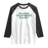 In A World Full Of Darkness Be A Light Raglan Shirt Christmas Quote Gift - Wonder Print Shop