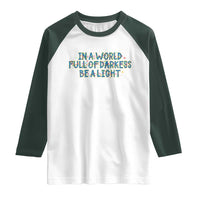 In A World Full Of Darkness Be A Light Raglan Shirt Christmas Quote Gift - Wonder Print Shop