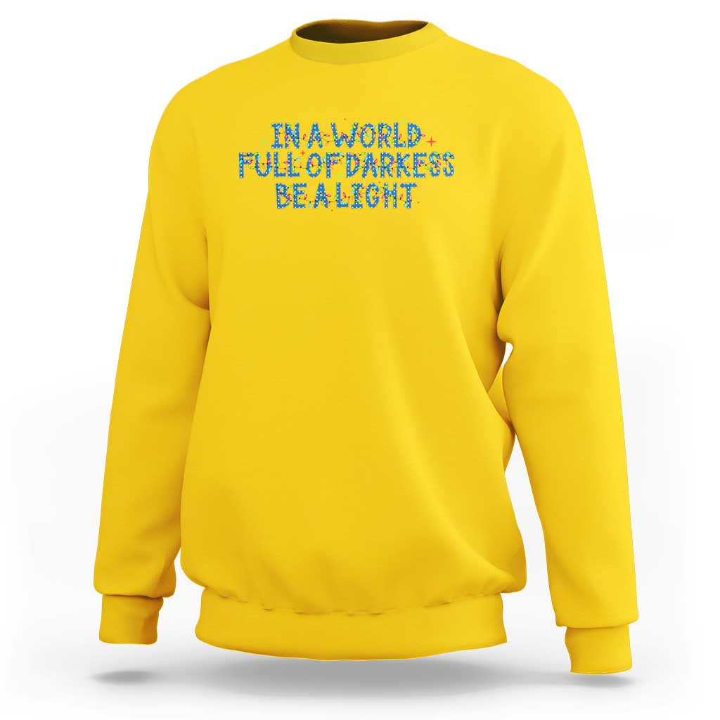 In A World Full Of Darkness Be A Light Sweatshirt Christmas Quote Gift - Wonder Print Shop