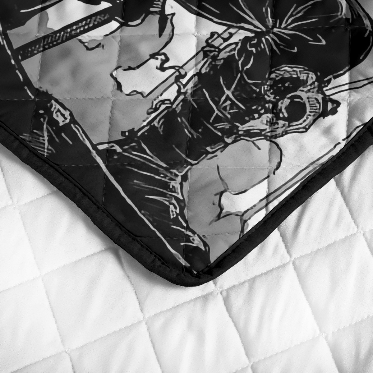 Quilt corner close-up: black trim, black-and-white warrior print, stitched diamond quilting