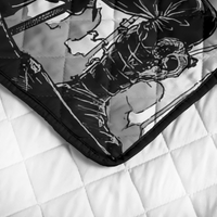 Quilt corner close-up: black trim, black-and-white warrior print, stitched diamond quilting