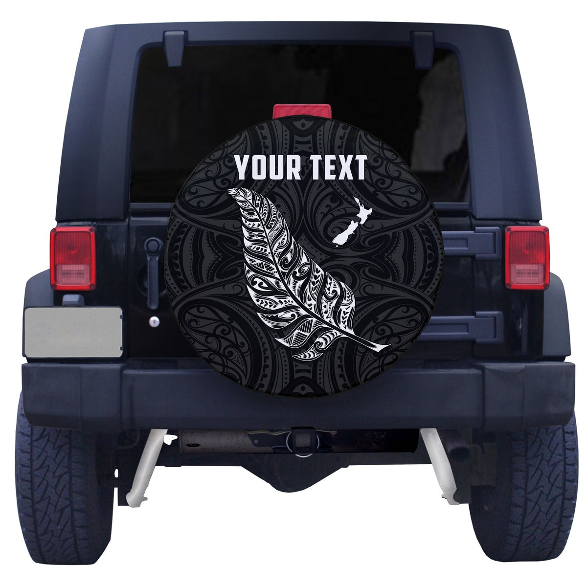 Black spare tire cover with ornate swirls, white fern, and 'YOUR TEXT' center