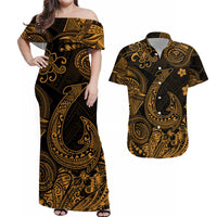 Off-shoulder maxi dress with black base and gold Polynesian-style scroll pattern