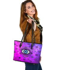 Pink small leather tote with evil eye print, black top handles and zipper