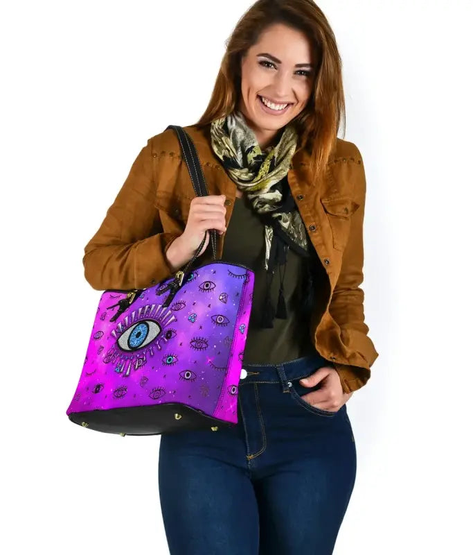 Pink evil eye leather tote bag with black top handles and wide open front