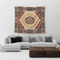 Freemasonry crest tapestry on wall, blue and red scrollwork border over cream center