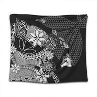 Black Hawaiian tapestry close-up with white ornamental florals, waves, and triangle motifs