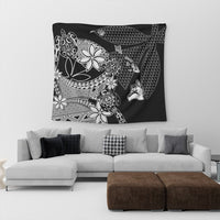 Black Hawaiian tapestry with white floral, geometric triangle patterns and stylized figures