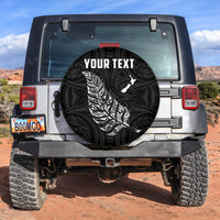 Black spare tire cover with white fern and 'YOUR TEXT' circular graphic
