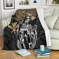 Black Hawaii king blanket with gold tribal pattern and white portrait, draped on sofa